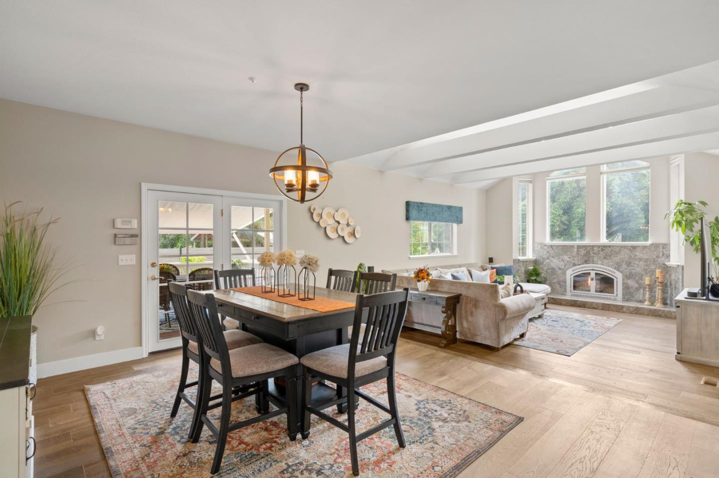 12135 Watsonville Road Gilroy, CA 95020 - Photo 14 of 83 a view of a dining room and livingroom with furniture wooden floor a chandelier