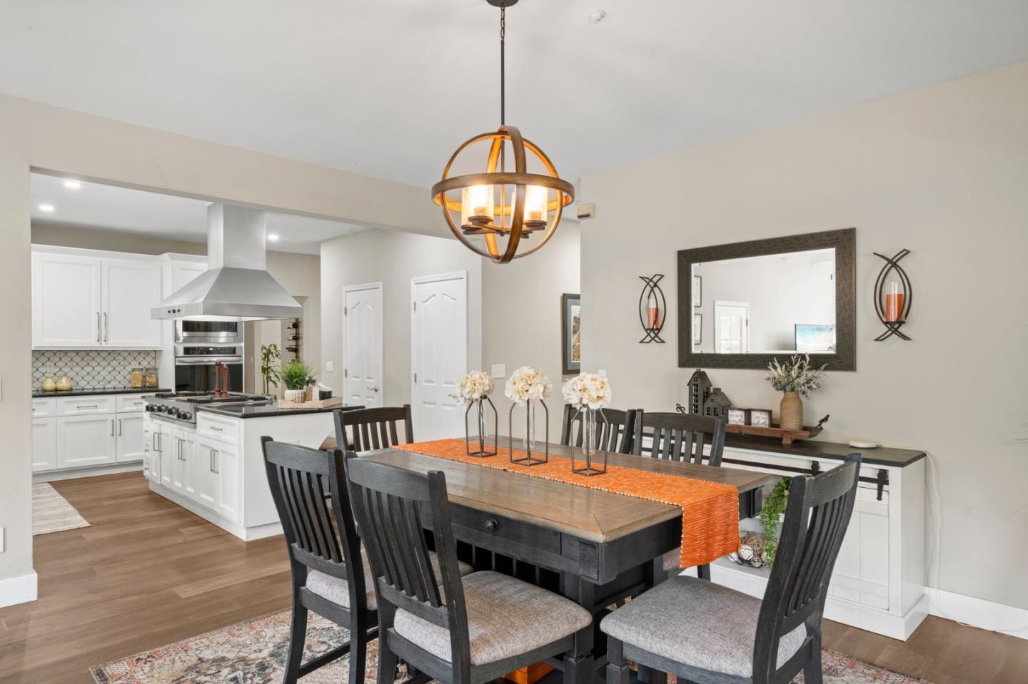 12135 Watsonville Road Gilroy, CA 95020 - Photo 15 of 83 a kitchen with stainless steel appliances granite countertop a dining table and chairs