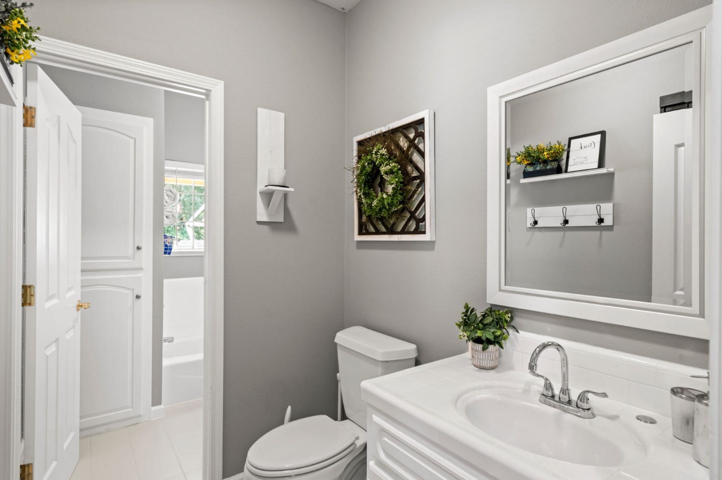 12135 Watsonville Road Gilroy, CA 95020 - Photo 20 of 83 a bathroom with a toilet a sink and a mirror