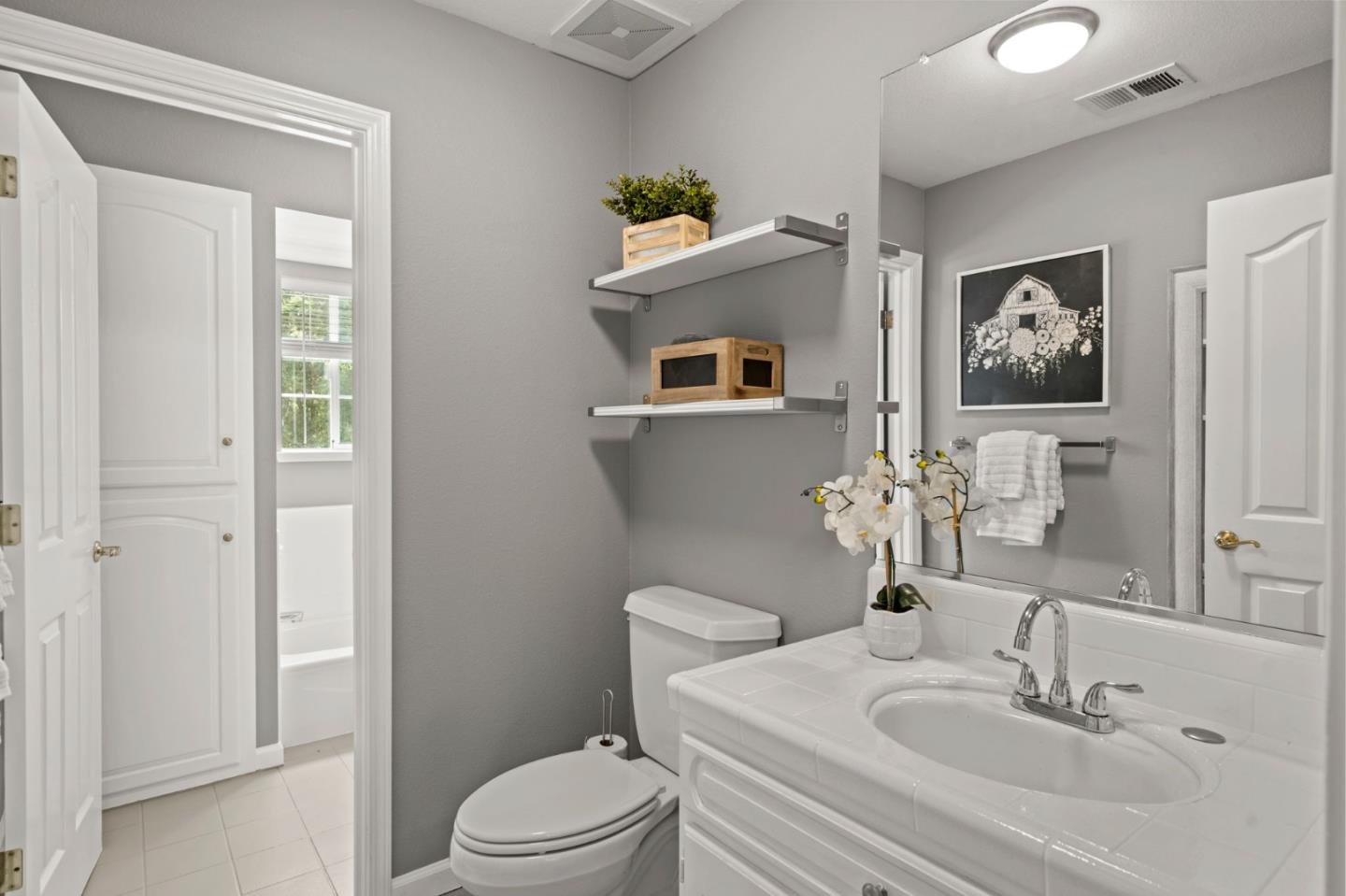 12135 Watsonville Road Gilroy, CA 95020 - Photo 25 of 83 a bathroom with a sink mirror and a toilet