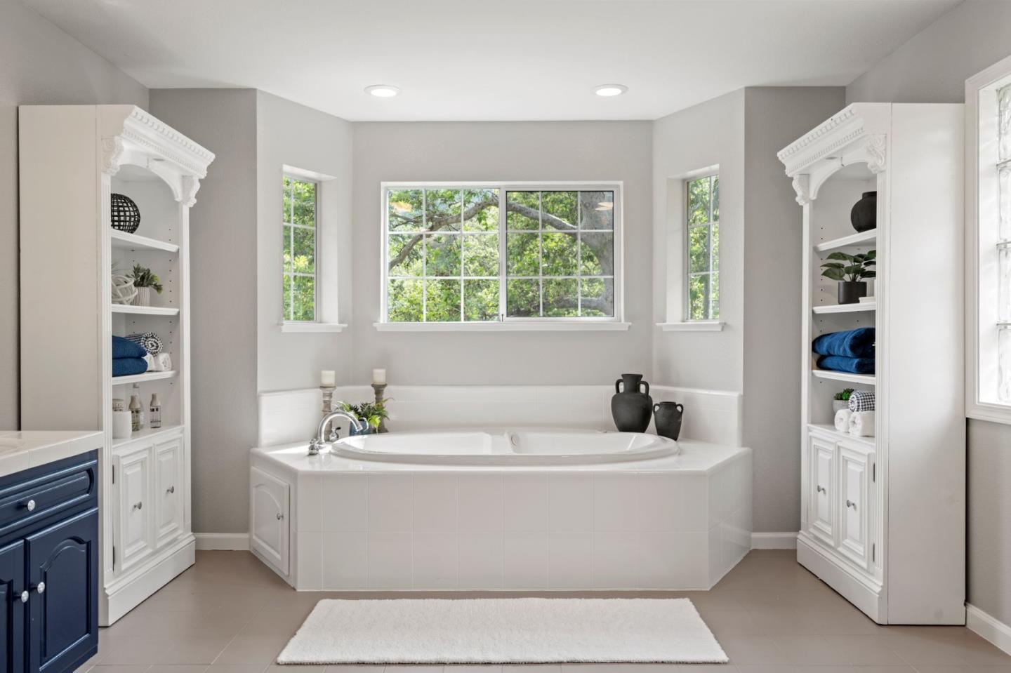 12135 Watsonville Road Gilroy, CA 95020 - Photo 33 of 83 a bathroom with bathtub a window a sink and a mirror