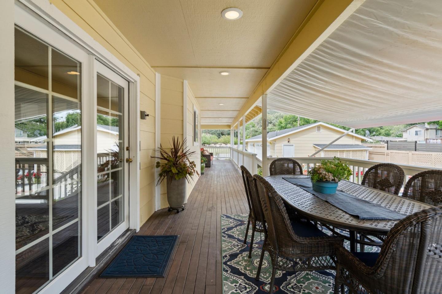 12135 Watsonville Road Gilroy, CA 95020 - Photo 45 of 83 a view of a patio with table and chairs with wooden floor and fence