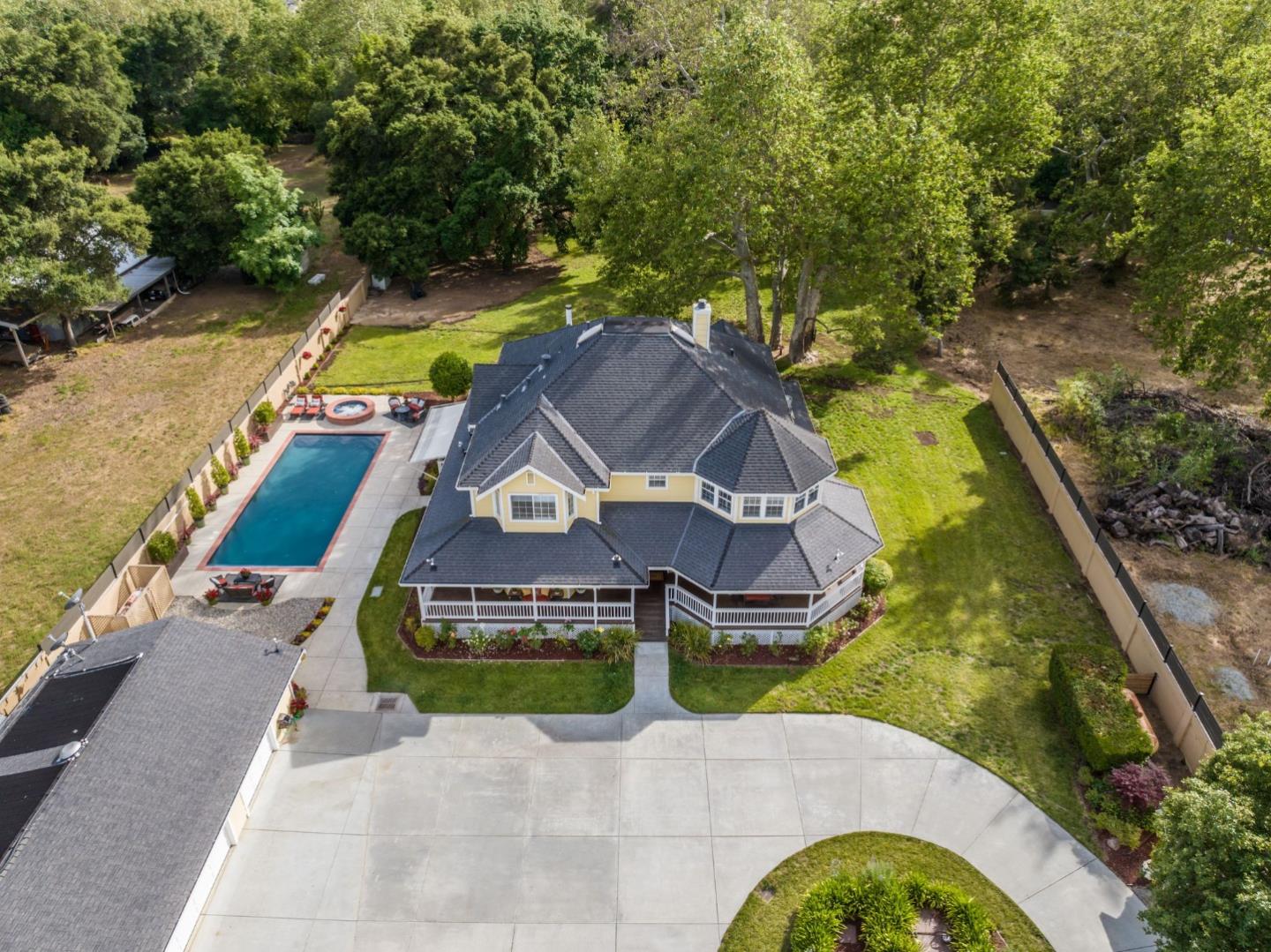 12135 Watsonville Road Gilroy, CA 95020 - Photo 81 of 83 an aerial view of a house with swimming pool and large trees