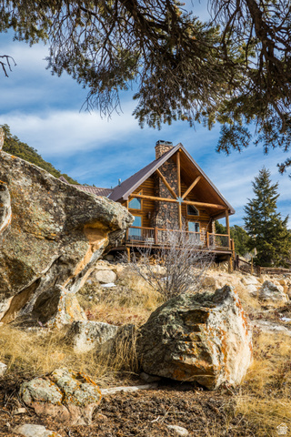 18906 North Canyon Road Whiterocks, UT 84085 - Photo 58 of 65 View of front of home featuring a chimney and a wooden deck