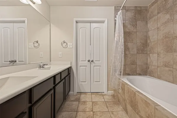 a view of a room with wooden floor and a ceiling fan
