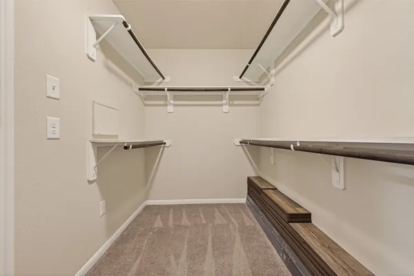 a view of a room with a ceiling fan and wooden floor