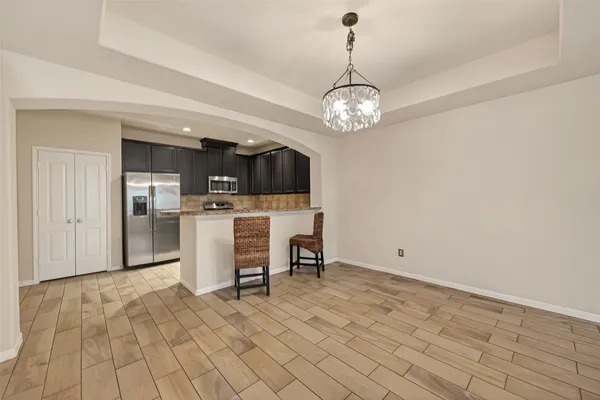 a view of a kitchen with a sink stainless steel appliances and cabinets
