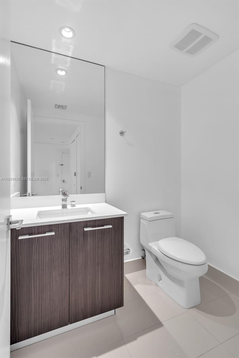 55 Southwest 9th Street, Unit 1109 Miami, FL 33130 - Photo 3 of 35 a bathroom with a sink toilet and mirror
