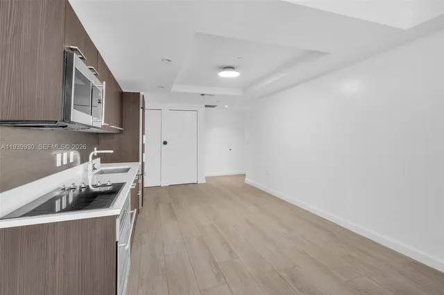 a kitchen with granite countertop a sink and a stove top oven