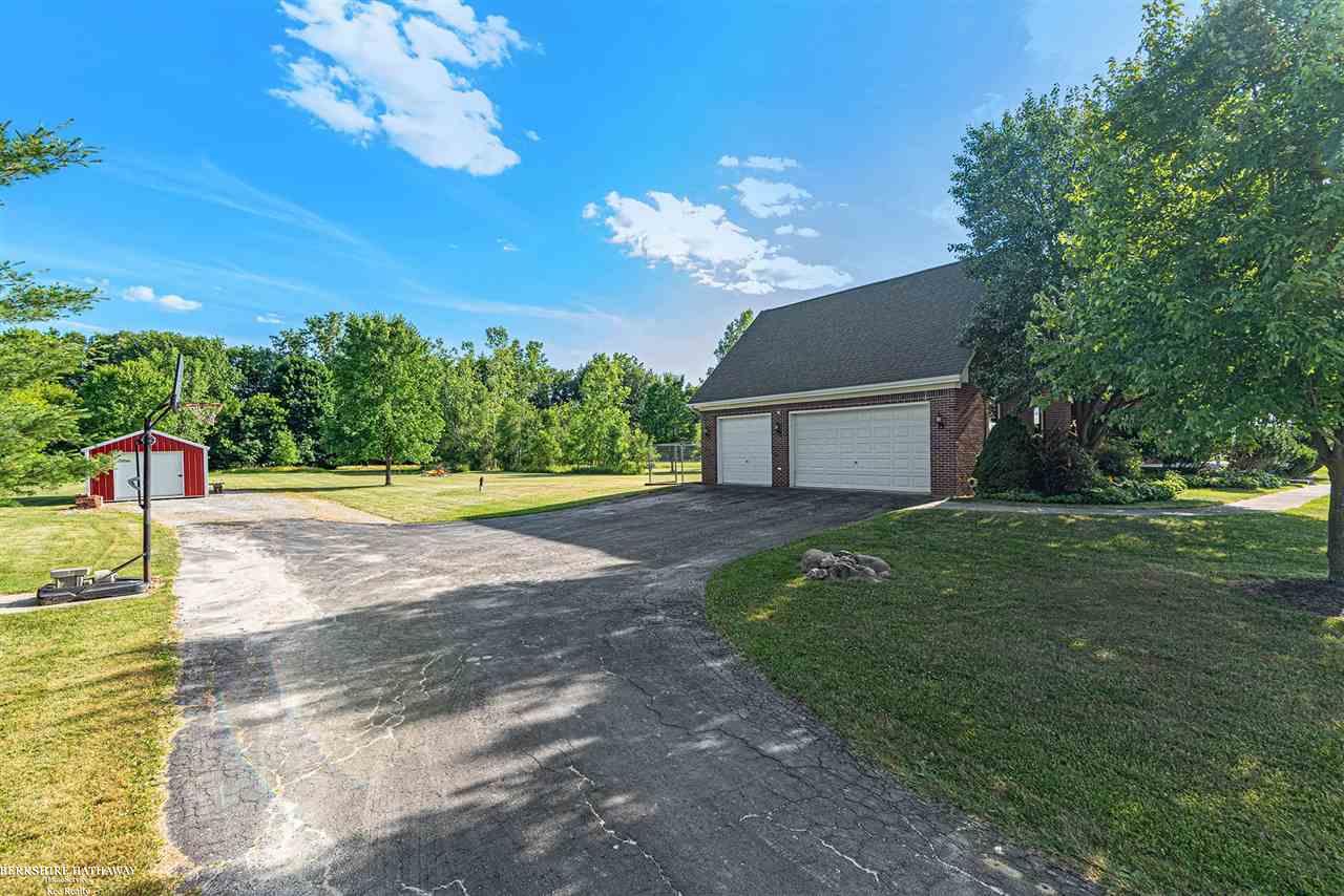 21240 Pratt Road Armada, MI 48005 - Photo 37 of 42 8' insulated garage doors. Door opener has new battery back-up feature. Storage room above garage with flooring and electrical. 30 AMP RV outlet in garage. 14 x 24 Amish built outbuilding at end of dr