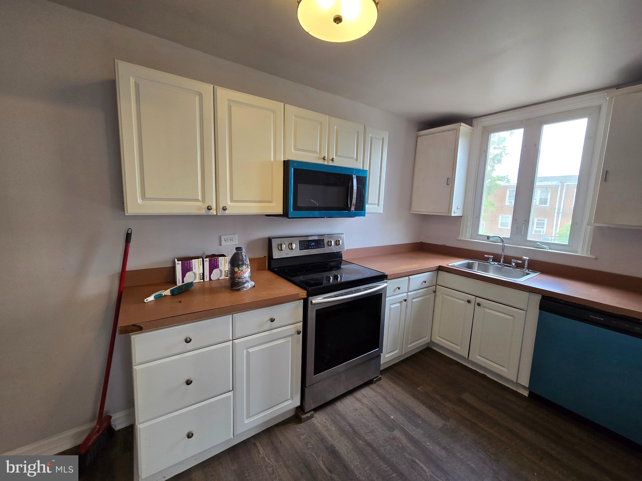 201 St Laurence Road Upper Darby, PA 19082 - Photo 13 of 37 a kitchen with granite countertop a stove a sink and a microwave
