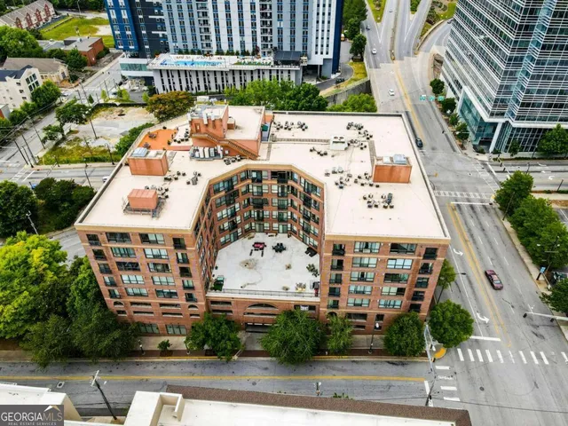 a view of a room with wooden floor air conditioner and windows