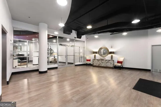 a living room with lots of furniture and white walls