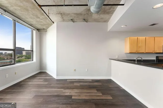 a view of a kitchen with wooden floor and a sink
