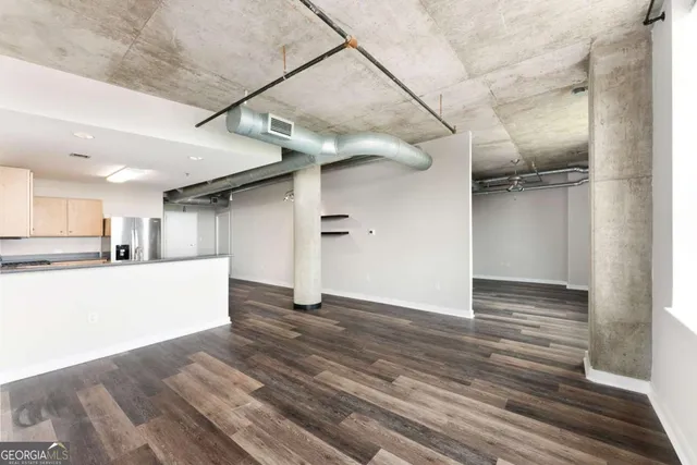 a view of empty room with wooden floor