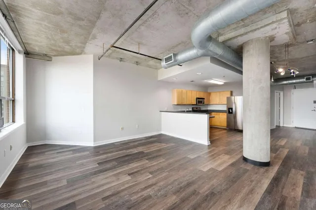 a view of a kitchen with a sink dishwasher a refrigerator and wooden floor