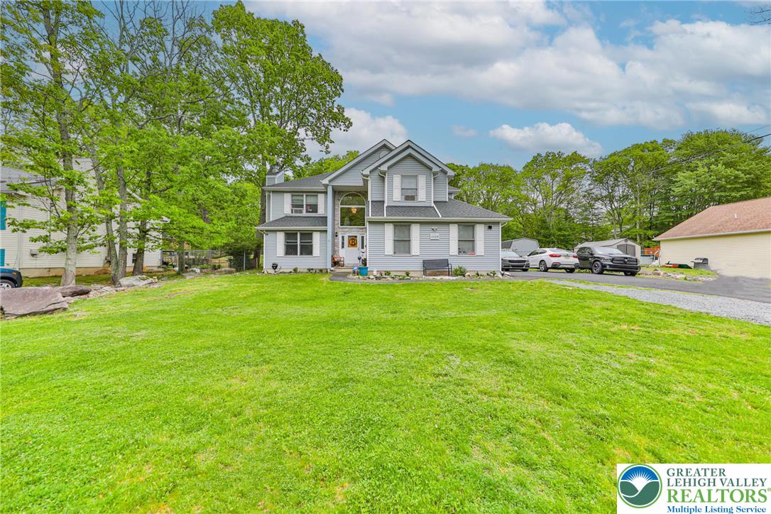 4608 Pine Ridge Drive West Bushkill, PA 18324 - Photo 5 of 62 A classic two-story home features a manicured front lawn and mature trees.