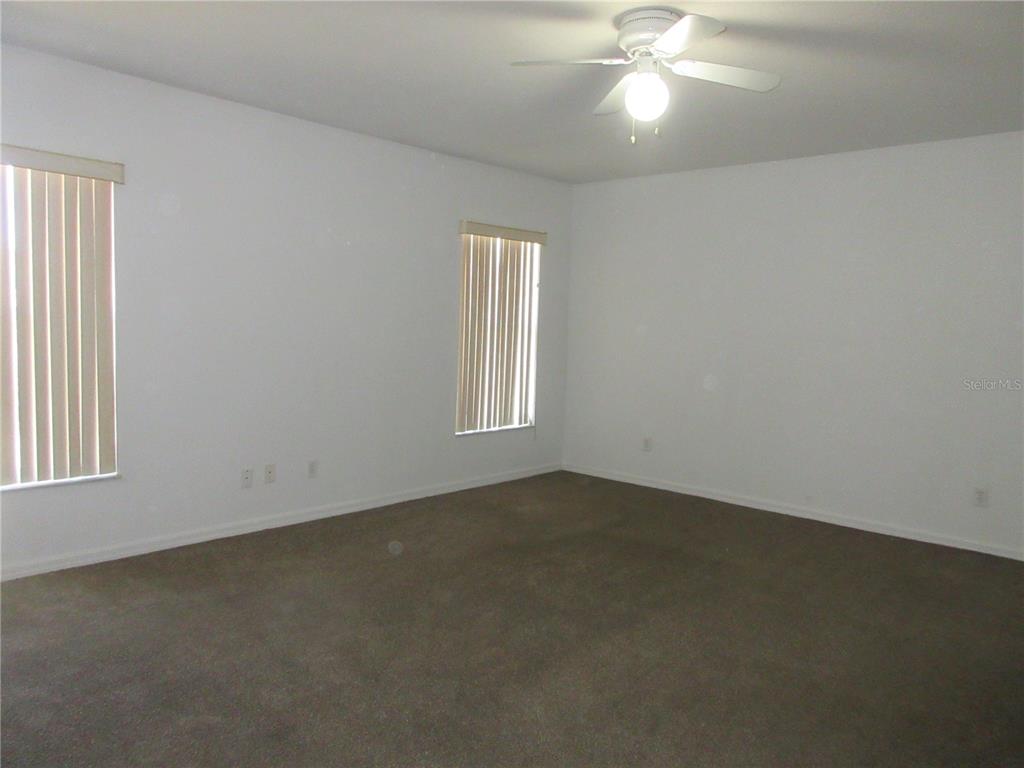 4760 Southwest 136th Place Ocala, FL 34473 - Photo 11 of 19 an empty room with a window and a ceiling fan