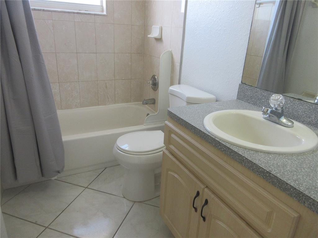 4760 Southwest 136th Place Ocala, FL 34473 - Photo 16 of 19 a bathroom with a granite countertop toilet a sink and bathtub