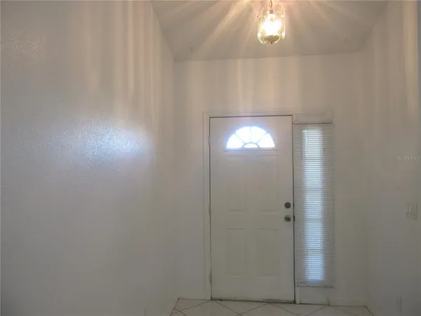 a bathroom with a light fixture and a window