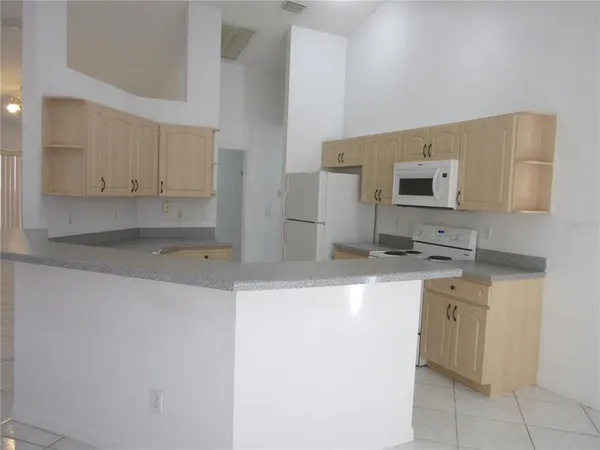 a kitchen with stainless steel appliances granite countertop a sink and a stove