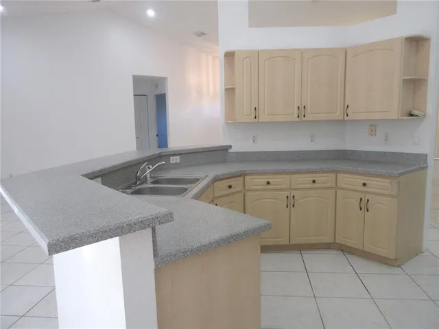 a kitchen with a sink cabinets and utility