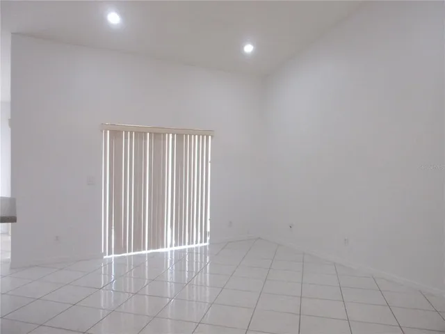 an empty room with white walls and tiles