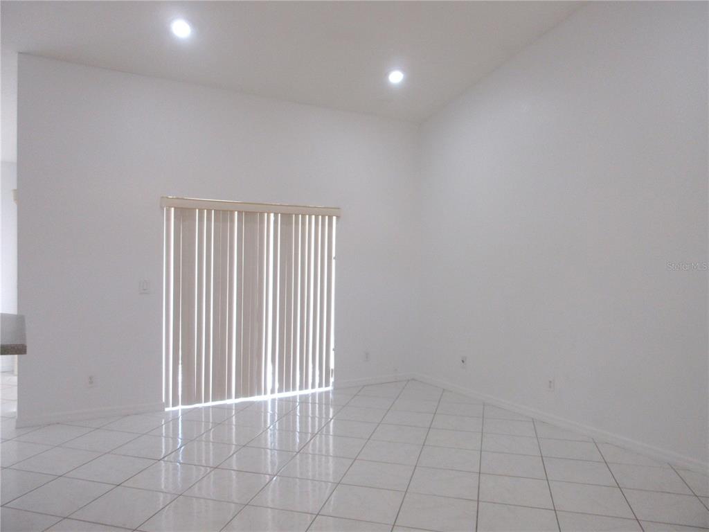 4760 Southwest 136th Place Ocala, FL 34473 - Photo 10 of 19 an empty room with white walls and tiles