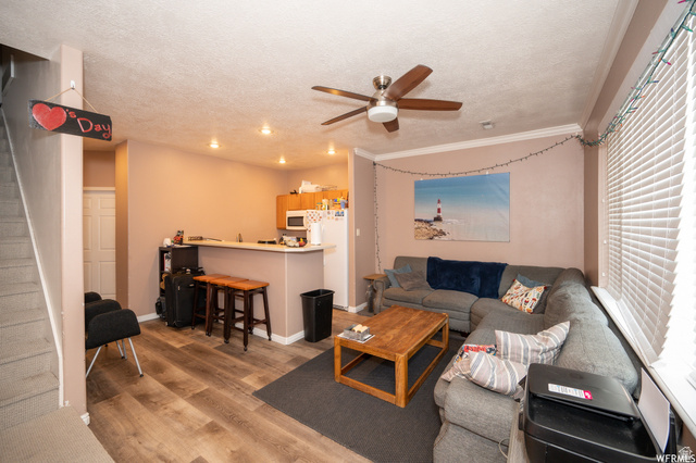 677 300 North, Unit 7 Provo, UT 84606 - Photo 4 of 16 Open-concept living space featuring wood-finish flooring, a ceiling fan with integrated lighting, and recessed ceiling lights