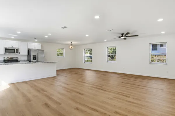 a kitchen with stainless steel appliances granite countertop a refrigerator and a stove top oven