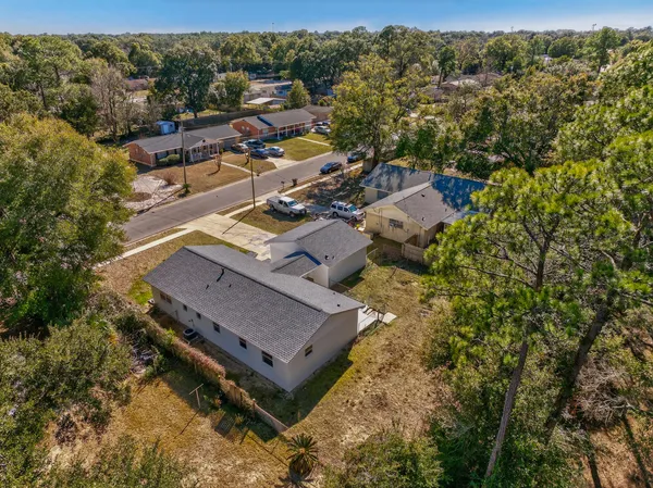 an aerial view of a house with a yard