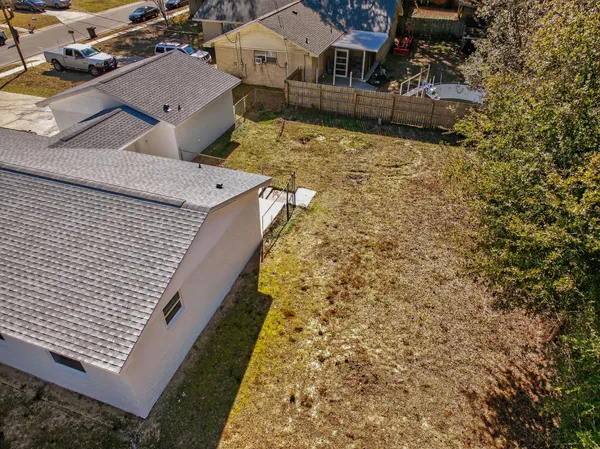 an aerial view of a house with a yard