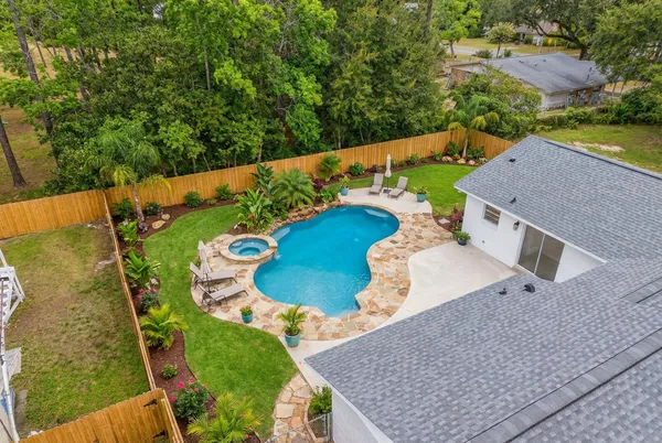 a view of a swimming pool with a yard
