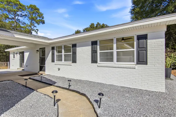 a view of a house with backyard and sitting area