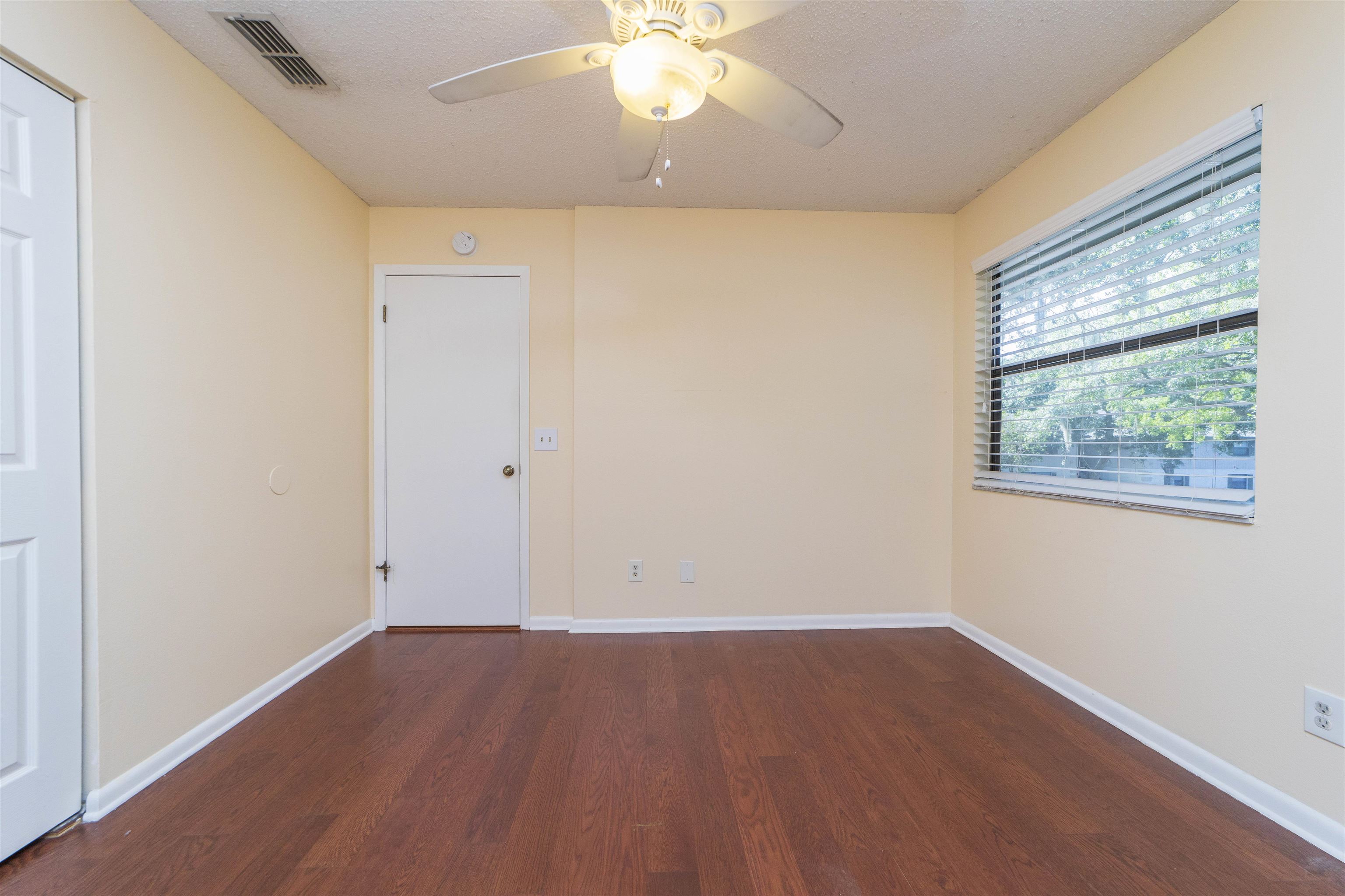 2 Catalonia Court St. Augustine, FL 32086 - Photo 16 of 28 wooden floor in an empty room with a window