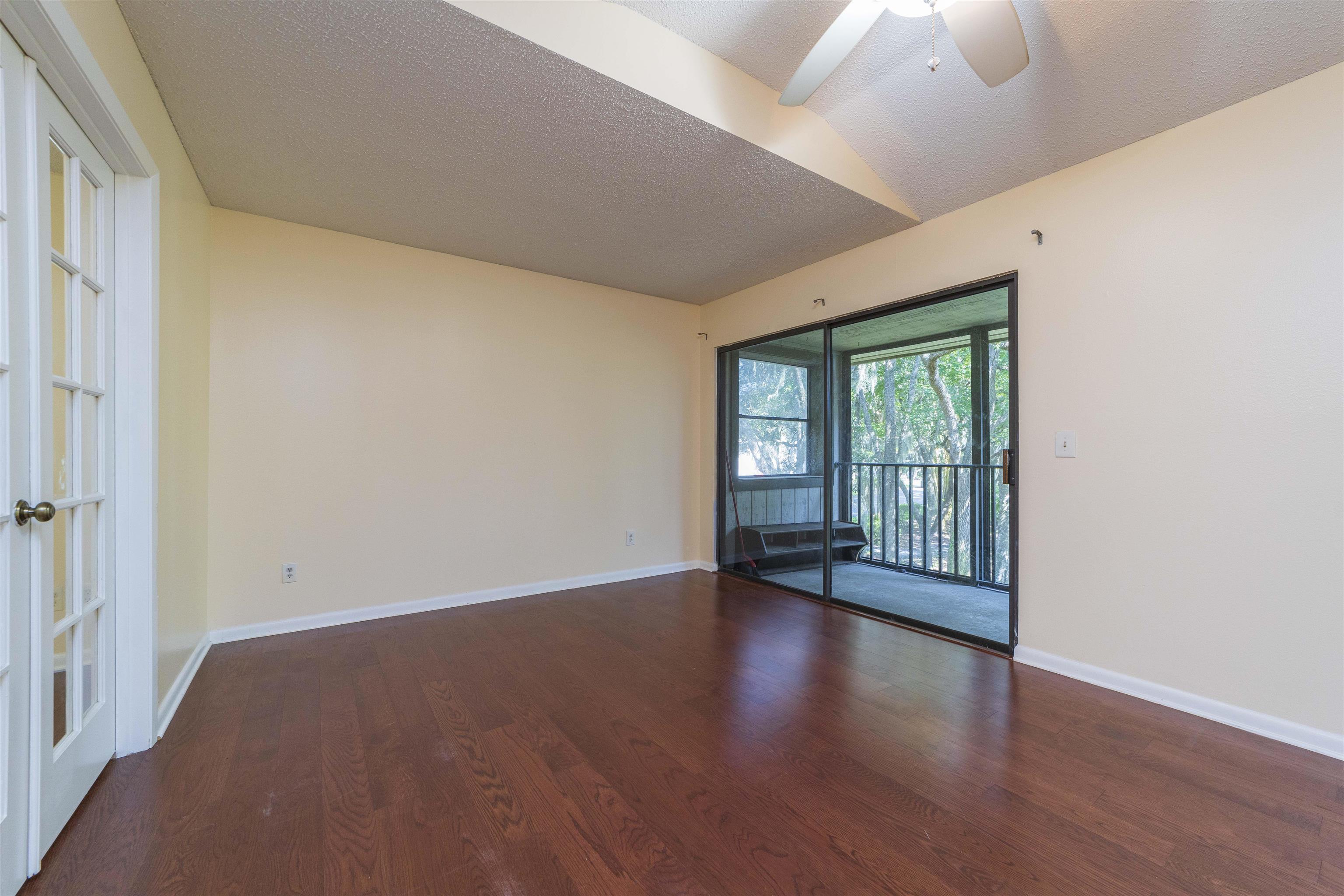 2 Catalonia Court St. Augustine, FL 32086 - Photo 22 of 28 a view of an empty room with a window and wooden floor