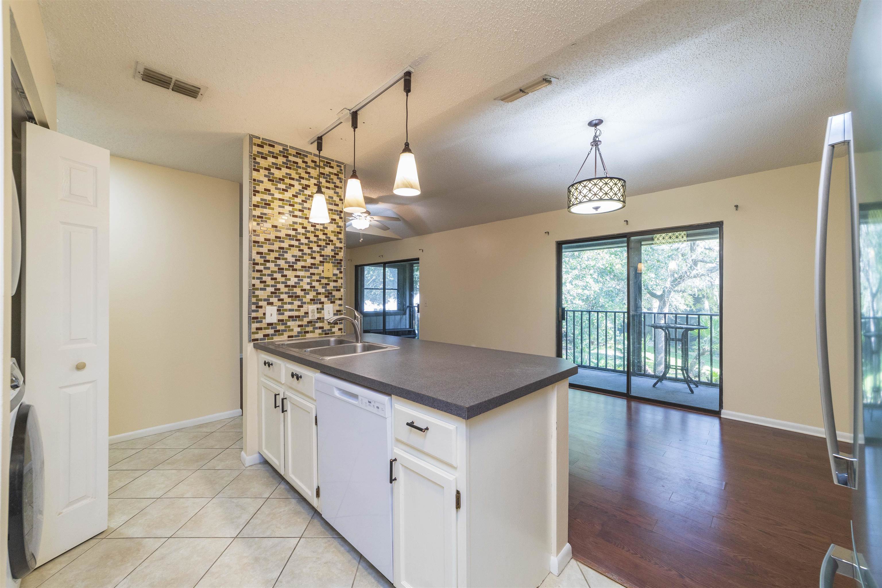 2 Catalonia Court St. Augustine, FL 32086 - Photo 5 of 28 a kitchen with stainless steel appliances granite countertop a sink a stove and a window