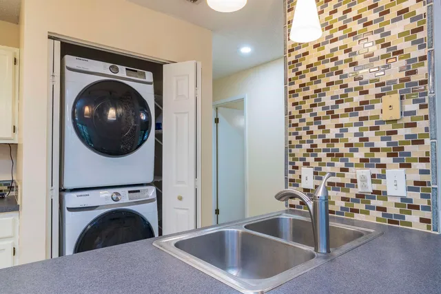 a utility room with a sink dryer and washer