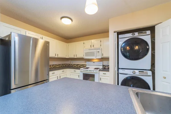 a kitchen with a refrigerator sink and stove top oven