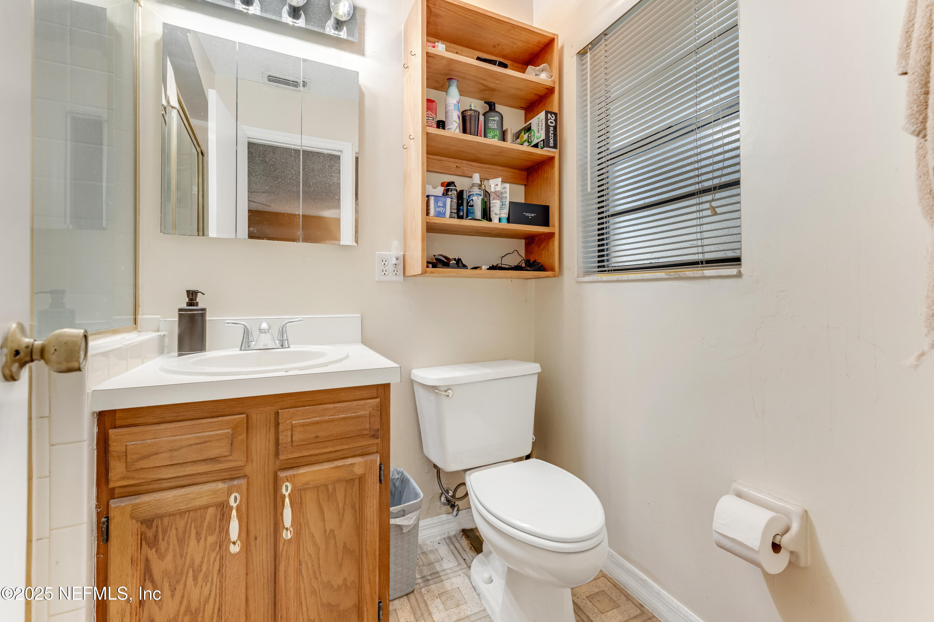 1399 Old Kings Road Daytona Beach, FL 32117 - Photo 11 of 27 a bathroom with a toilet sink and mirror