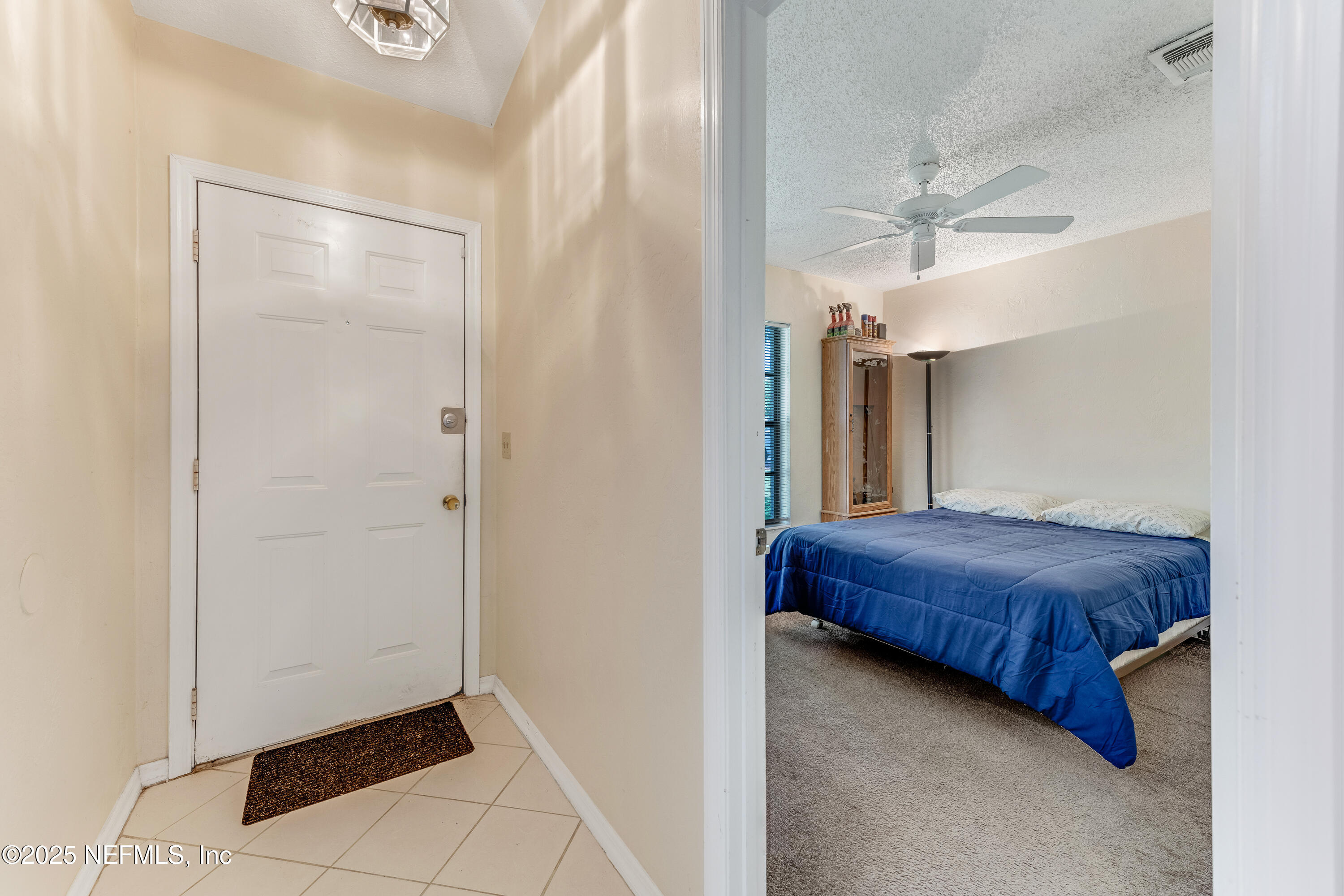 1399 Old Kings Road Daytona Beach, FL 32117 - Photo 3 of 27 a bedroom with a bed and a mirror