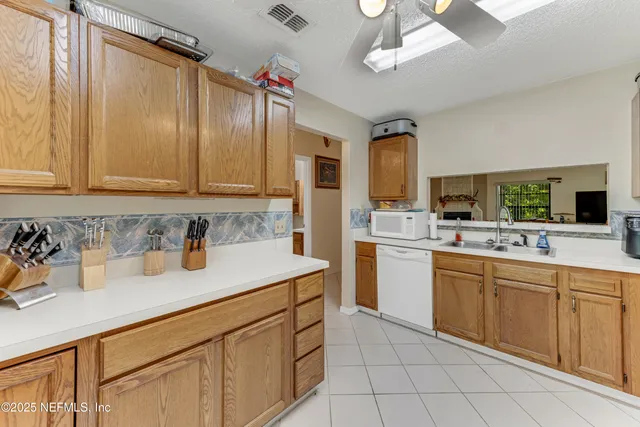 a kitchen with cabinets and stainless steel appliances
