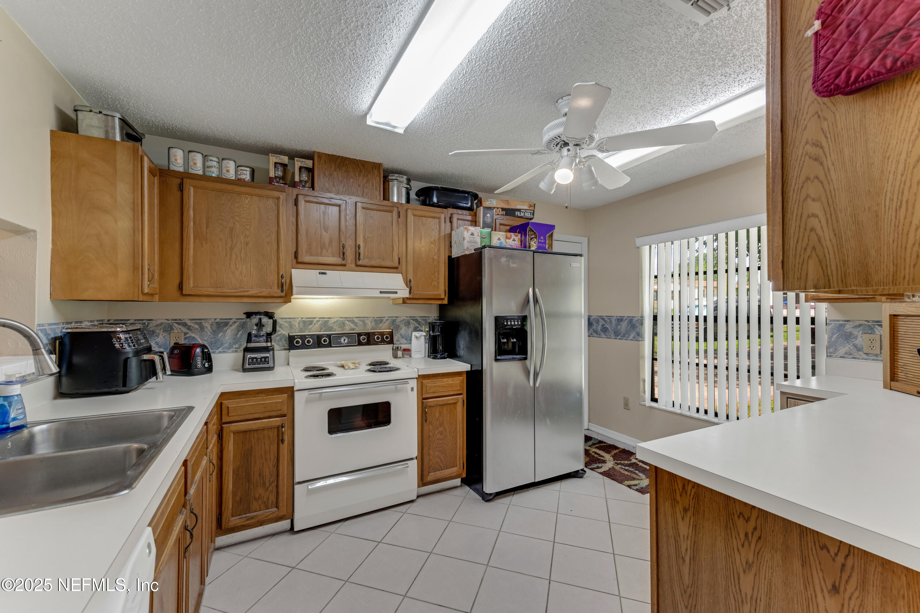 1399 Old Kings Road Daytona Beach, FL 32117 - Photo 7 of 27 a kitchen with cabinets and stainless steel appliances