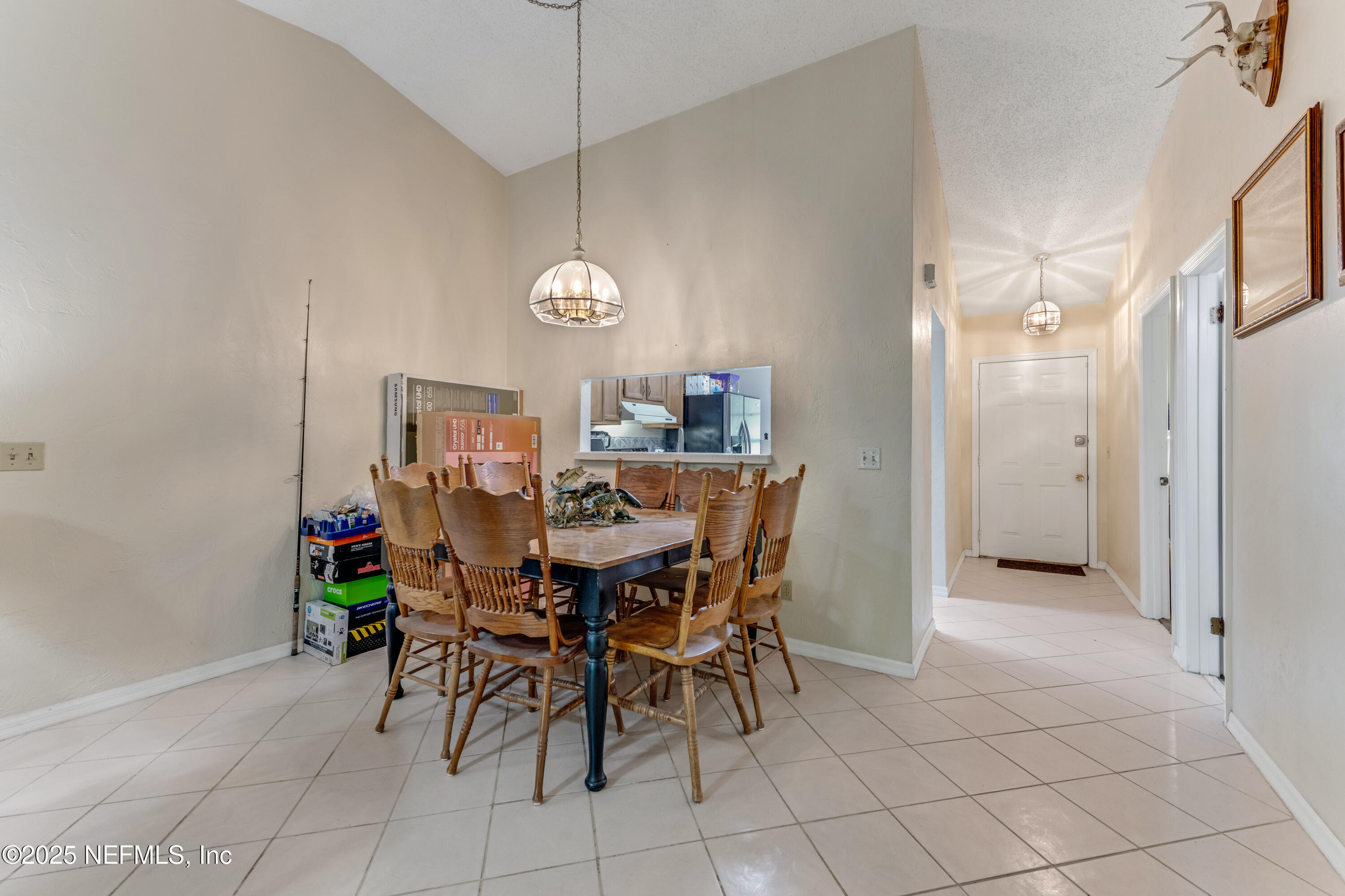 1399 Old Kings Road Daytona Beach, FL 32117 - Photo 8 of 27 a view of a dining room with furniture and chandelier