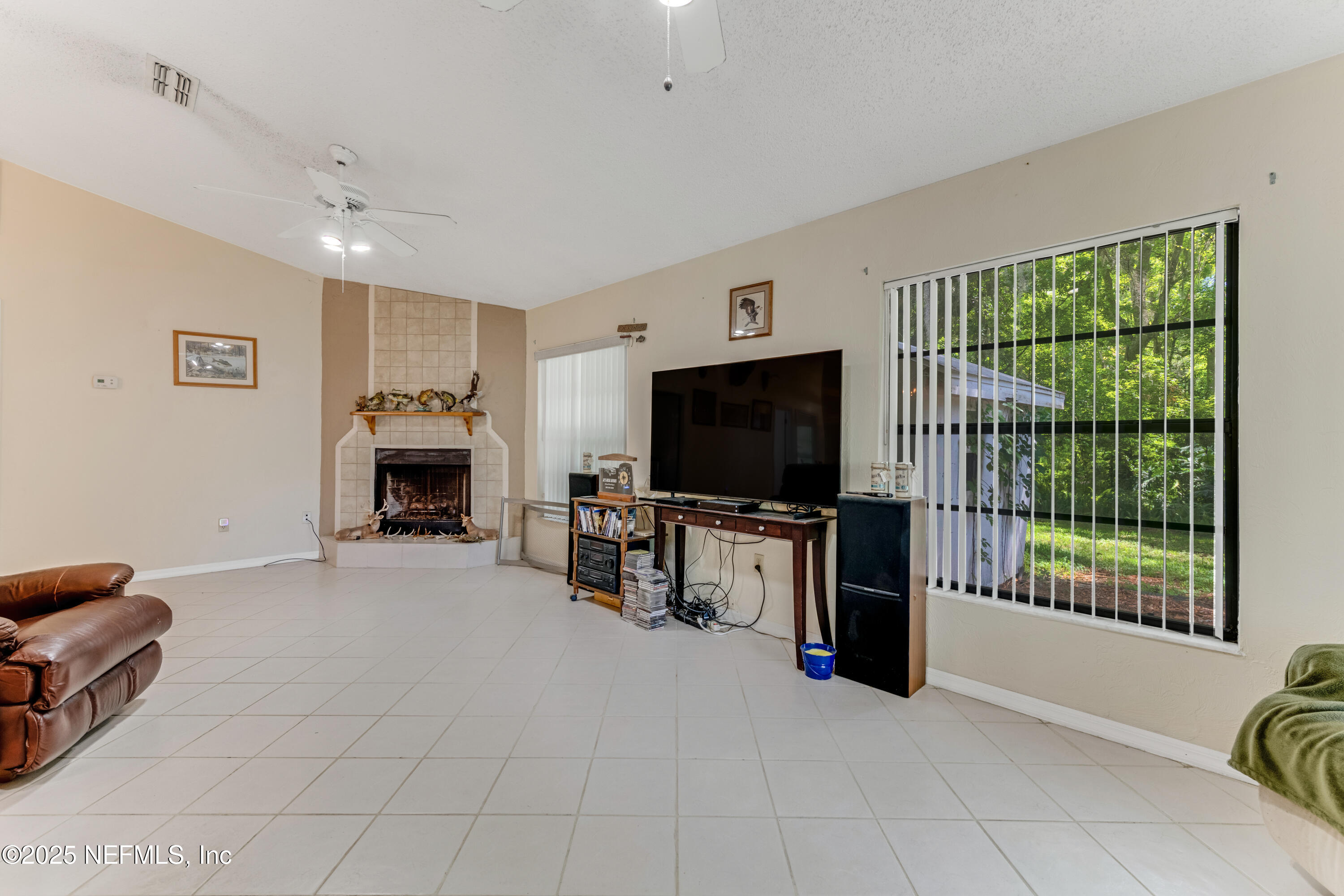 1399 Old Kings Road Daytona Beach, FL 32117 - Photo 9 of 27 a living room with furniture and a flat screen tv