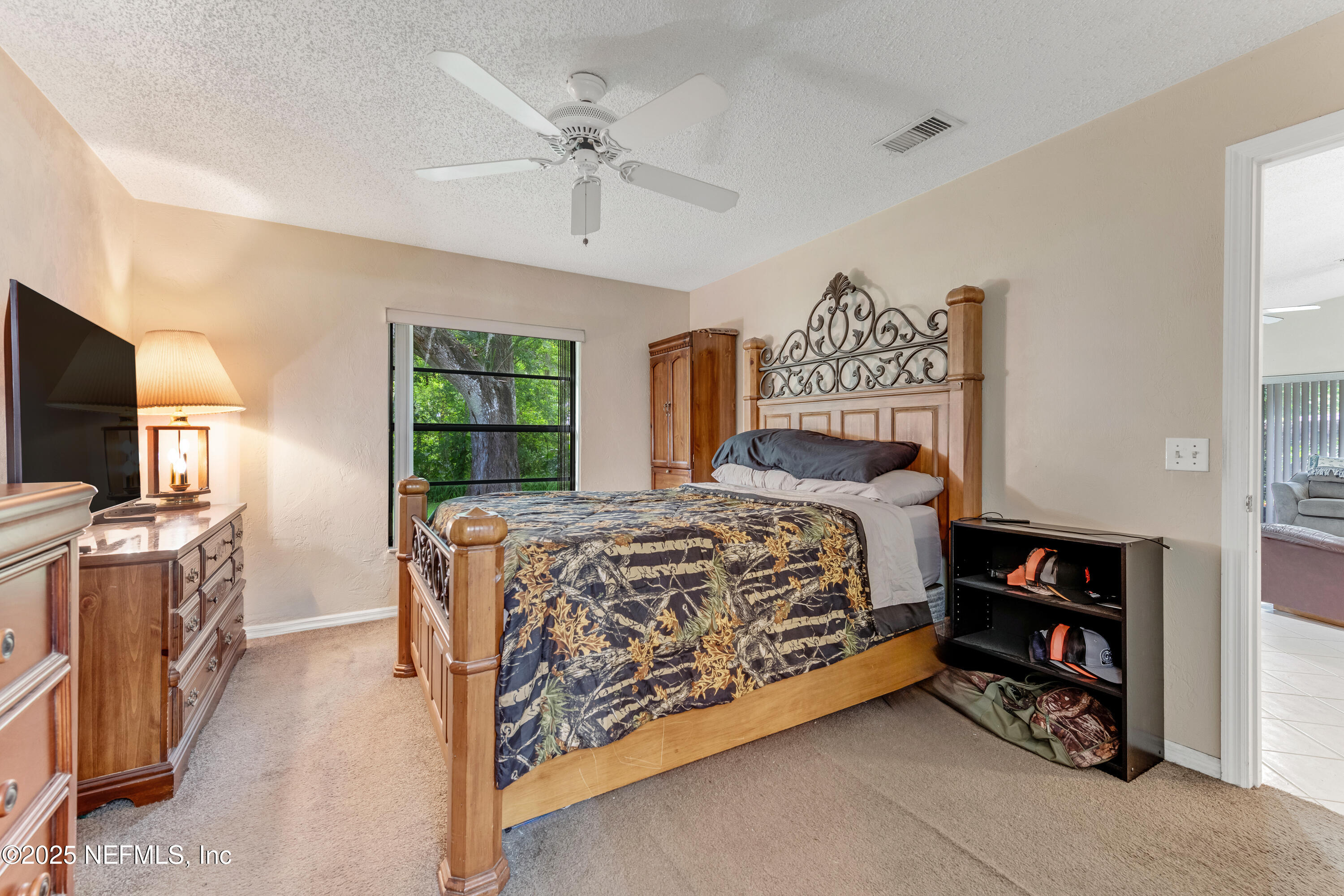 1399 Old Kings Road Daytona Beach, FL 32117 - Photo 10 of 27 a bed room with a bed and a television