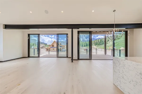 an empty room with large windows