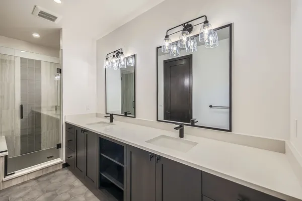 a bathroom with a sink a toilet and mirror