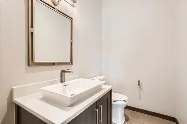 a bathroom with a double vanity sink mirror and bathtub