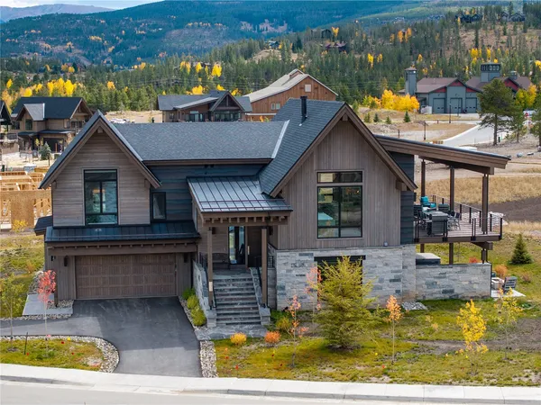 a view of a house with pool and chairs